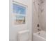 Simple bathroom with a bathtub, shower, and window at 1303 S 8Th St, Las Vegas, NV 89104