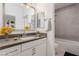 Modern bathroom with gray tile, white vanity, and a bathtub at 816 Franklin Ave, Las Vegas, NV 89104