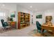 Home office with two desks, built-in shelving, and teal chairs at 816 Franklin Ave, Las Vegas, NV 89104