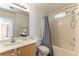 Clean bathroom, shower/tub combo and wood vanity at 10957 Civiletti St, Las Vegas, NV 89141