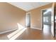 Light-filled bedroom with wood floors and access to another room at 10957 Civiletti St, Las Vegas, NV 89141