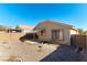 Tan house exterior with a small patio and backyard at 10957 Civiletti St, Las Vegas, NV 89141