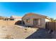 Tan house exterior with a small patio and backyard at 10957 Civiletti St, Las Vegas, NV 89141