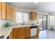 Kitchen with oak cabinets, tile floors, and a double sink at 10957 Civiletti St, Las Vegas, NV 89141