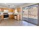 Kitchen with oak cabinets, tile floors, and sliding glass door at 10957 Civiletti St, Las Vegas, NV 89141