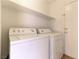 Bright laundry room with washer, dryer, and shelving at 10957 Civiletti St, Las Vegas, NV 89141