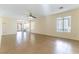 Living room with tile floors, sliding glass doors, and a ceiling fan at 10957 Civiletti St, Las Vegas, NV 89141
