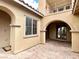 Private courtyard entry with brick pavers and arched doorways at 12133 Vista Linda Ave, Las Vegas, NV 89138