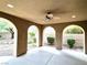 Covered patio with arched entryways, ceiling fan, and access to backyard at 12133 Vista Linda Ave, Las Vegas, NV 89138