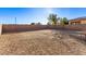 Large gravel backyard with a playset and a block wall at 1413 Fantastic Ct, North Las Vegas, NV 89081