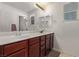 Double vanity bathroom with wood cabinets at 1413 Fantastic Ct, North Las Vegas, NV 89081