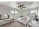 Bedroom with vanity, ceiling fan and large bed at 1413 Fantastic Ct, North Las Vegas, NV 89081