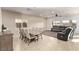 Open concept dining area with a large table and adjacent living room at 1413 Fantastic Ct, North Las Vegas, NV 89081