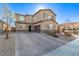 Two-story house with gray shutters, stone accents, and a paved driveway at 1413 Fantastic Ct, North Las Vegas, NV 89081