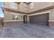 Brown double-car garage with a paved driveway at 1413 Fantastic Ct, North Las Vegas, NV 89081
