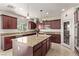 Island kitchen with granite countertops and dark wood cabinets at 1413 Fantastic Ct, North Las Vegas, NV 89081