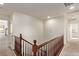 Upstairs hallway with wood railing and multiple doors at 1413 Fantastic Ct, North Las Vegas, NV 89081
