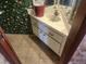 Small bathroom with corner sink and floral wallpaper at 1487 Elaine Dr, Las Vegas, NV 89142