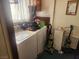 Laundry room with washer, dryer, and various cleaning supplies at 1487 Elaine Dr, Las Vegas, NV 89142