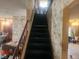 Image of a carpeted staircase with a wooden railing at 1487 Elaine Dr, Las Vegas, NV 89142