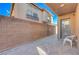 Small paved backyard with a sitting area and a wall at 152 Belmont Canyon Pl, Henderson, NV 89015