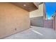 Small paved backyard with a wall and partial view of another house at 152 Belmont Canyon Pl, Henderson, NV 89015