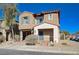 Tan two-story house with blue shutters and a brick walkway at 152 Belmont Canyon Pl, Henderson, NV 89015