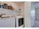 Convenient laundry room with washer, dryer, and shelving at 152 Belmont Canyon Pl, Henderson, NV 89015