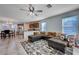 Open living room with L-shaped sectional sofa and adjacent kitchen at 152 Belmont Canyon Pl, Henderson, NV 89015