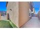 Small grassy side yard with a paved walkway and gate at 152 Belmont Canyon Pl, Henderson, NV 89015