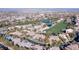 Community aerial view with golf course, scenic mountain backdrop, and lush landscaping at 1549 Foothills Village Dr, Henderson, NV 89012