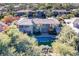 Aerial view of the estate showcasing the pool, lush landscaping, and elegant architecture at 1549 Foothills Village Dr, Henderson, NV 89012