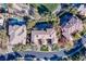 Aerial view showcasing the home's manicured lawn, pool, and verdant landscaping at 1549 Foothills Village Dr, Henderson, NV 89012