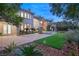 Expansive backyard with brick patio, manicured lawn, and luxurious pool, perfect for outdoor entertaining at 1549 Foothills Village Dr, Henderson, NV 89012