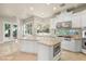 Well-equipped kitchen featuring a center island, stainless steel appliances, and natural light at 1549 Foothills Village Dr, Henderson, NV 89012