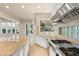 Bright kitchen with island, garden window, stainless steel oven and gas range at 1549 Foothills Village Dr, Henderson, NV 89012