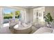 Comfortable living area with folding glass doors opening to the patio and pool at 1549 Foothills Village Dr, Henderson, NV 89012