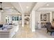 Bright and airy living room featuring neutral tones, recessed lighting, and seamless transition to the kitchen at 1549 Foothills Village Dr, Henderson, NV 89012