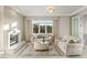 Cozy living room featuring a fireplace, plush seating, and soft natural light at 1549 Foothills Village Dr, Henderson, NV 89012