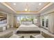 Serene main bedroom with plush carpet, ambient lighting, and balcony access at 1549 Foothills Village Dr, Henderson, NV 89012