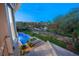 Backyard oasis with a sparkling pool, lush landscaping, and serene views at 1549 Foothills Village Dr, Henderson, NV 89012