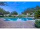 Beautiful swimming pool and spa surrounded by lush landscaping, creating a private oasis for relaxation at 1549 Foothills Village Dr, Henderson, NV 89012