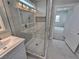 Bathroom with a walk-in shower, single vanity, and grey tile at 1770 Ironside St, Pahrump, NV 89048