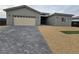 Modern single-story home with neutral exterior and paver driveway at 1770 Ironside St, Pahrump, NV 89048