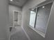 Hallway with window, grey flooring, and access to backyard at 1770 Ironside St, Pahrump, NV 89048