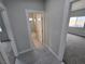 Grey-floored hallway with access to bedrooms and bath at 1770 Ironside St, Pahrump, NV 89048