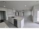 Modern kitchen with white cabinets, island, and stainless steel appliances at 1770 Ironside St, Pahrump, NV 89048