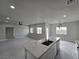 Open concept kitchen with island, white cabinets, and modern appliances at 1770 Ironside St, Pahrump, NV 89048