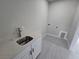 Bright laundry room with a utility sink and space for washer and dryer at 1770 Ironside St, Pahrump, NV 89048