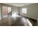 Bright bedroom with wood-look floors and patio access at 1880 Hollywell St, Las Vegas, NV 89135